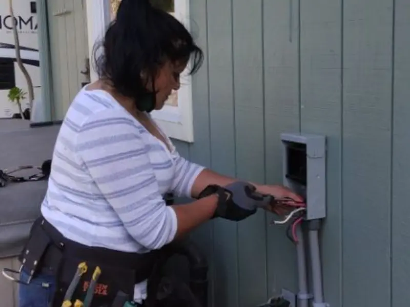 Licensed electrician wiring an exterior subpanel in Planada